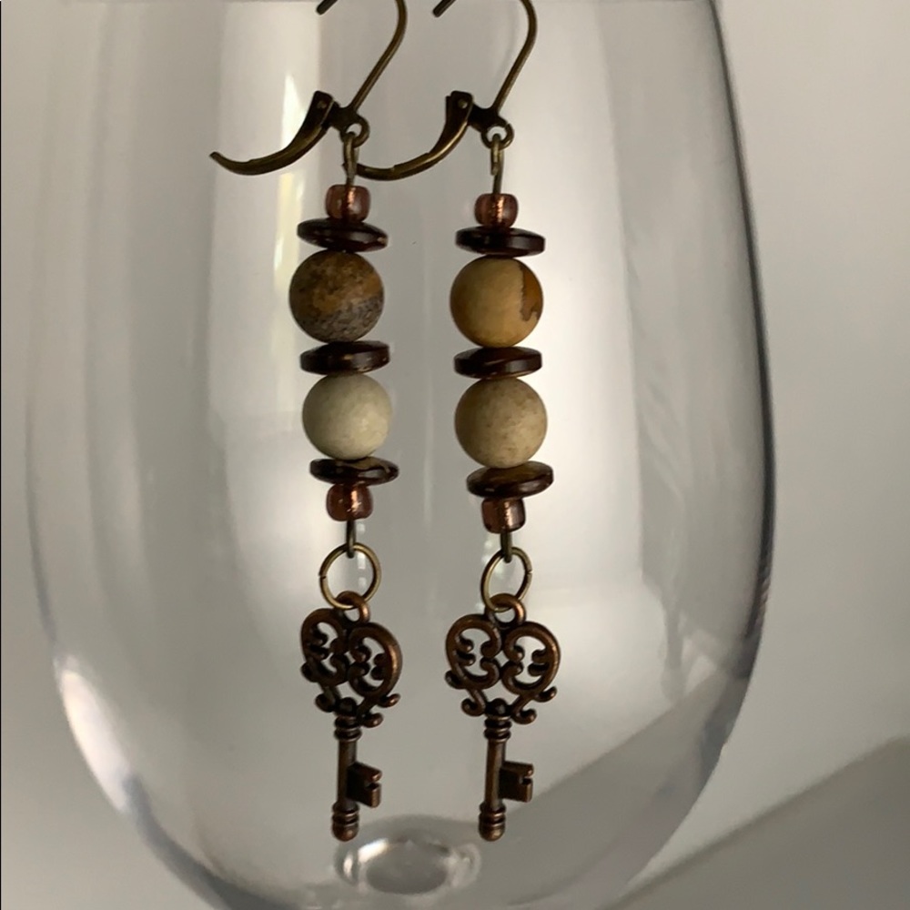 Brown stone earrings with bronze key